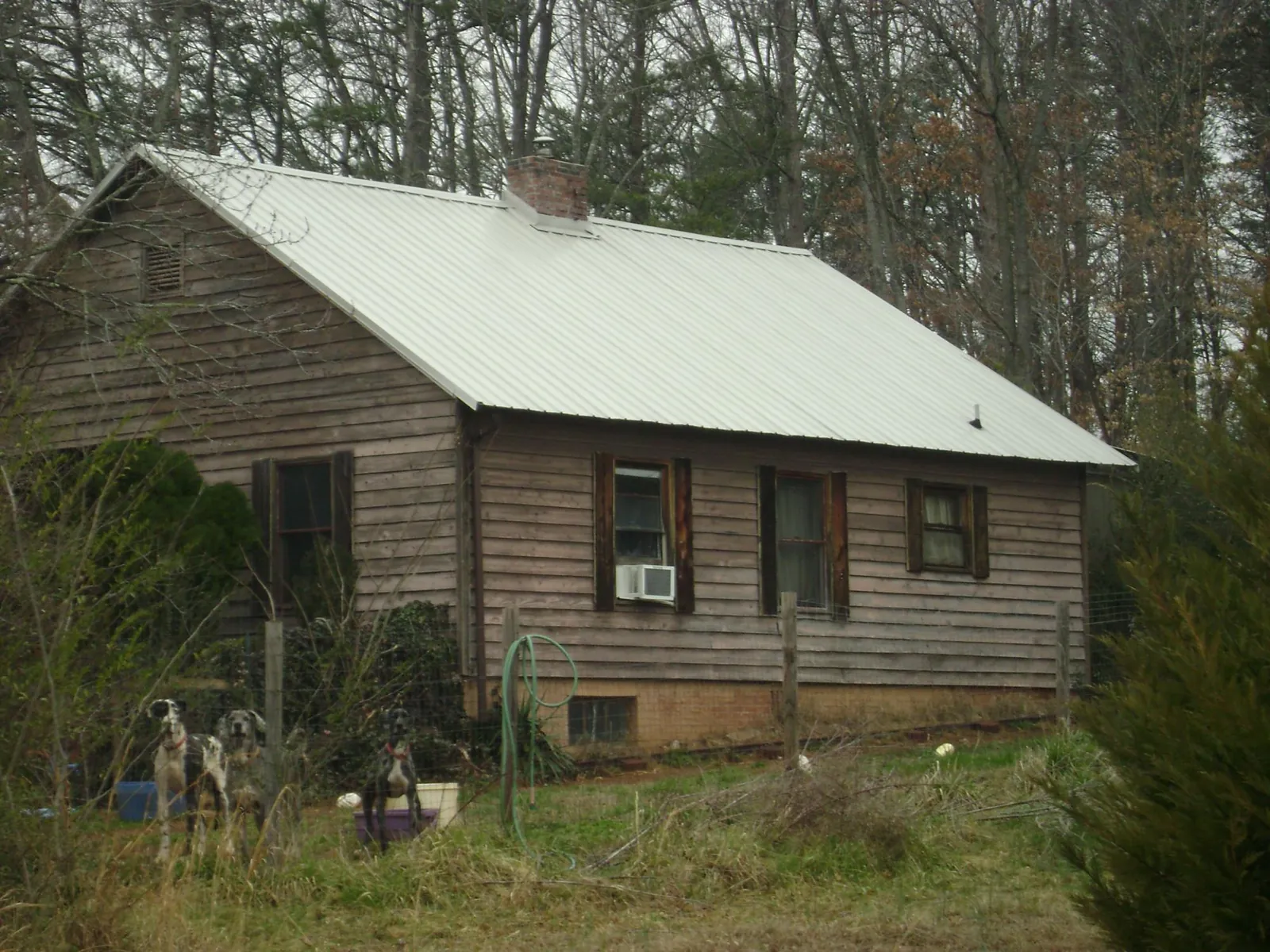 White metal roof on an old wood sided farmhouse, from a Metal Roof Installation job in Nunn